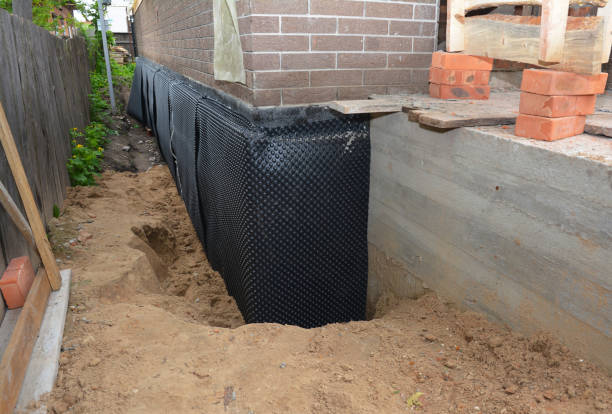 Happy homeowners after waterproofing job in Dorr